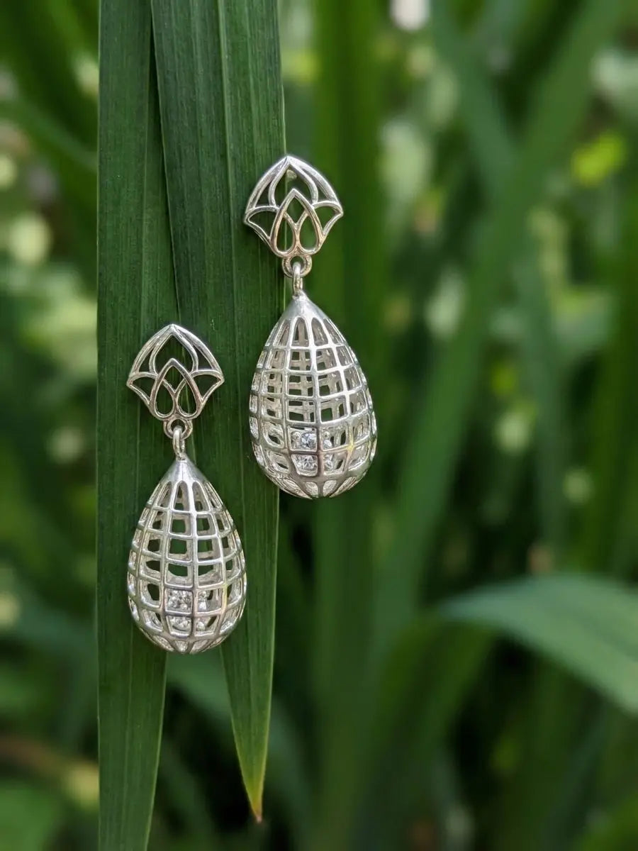 Silver teardrop earrings with intricate cage style design