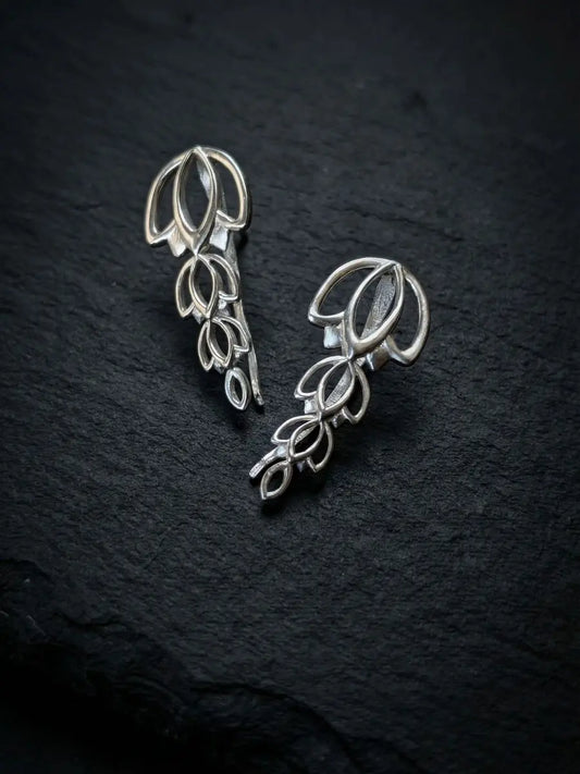Silver climber earring in a floral design worn by model